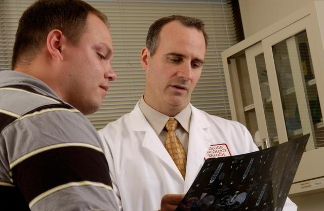 Physician consulting with patient while reviewing X-ray